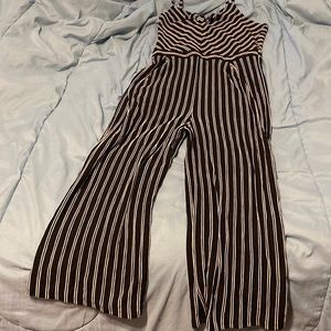 1X Jumpsuit.Has spaghetti straps,stretchable material, legs flare at the bottom.